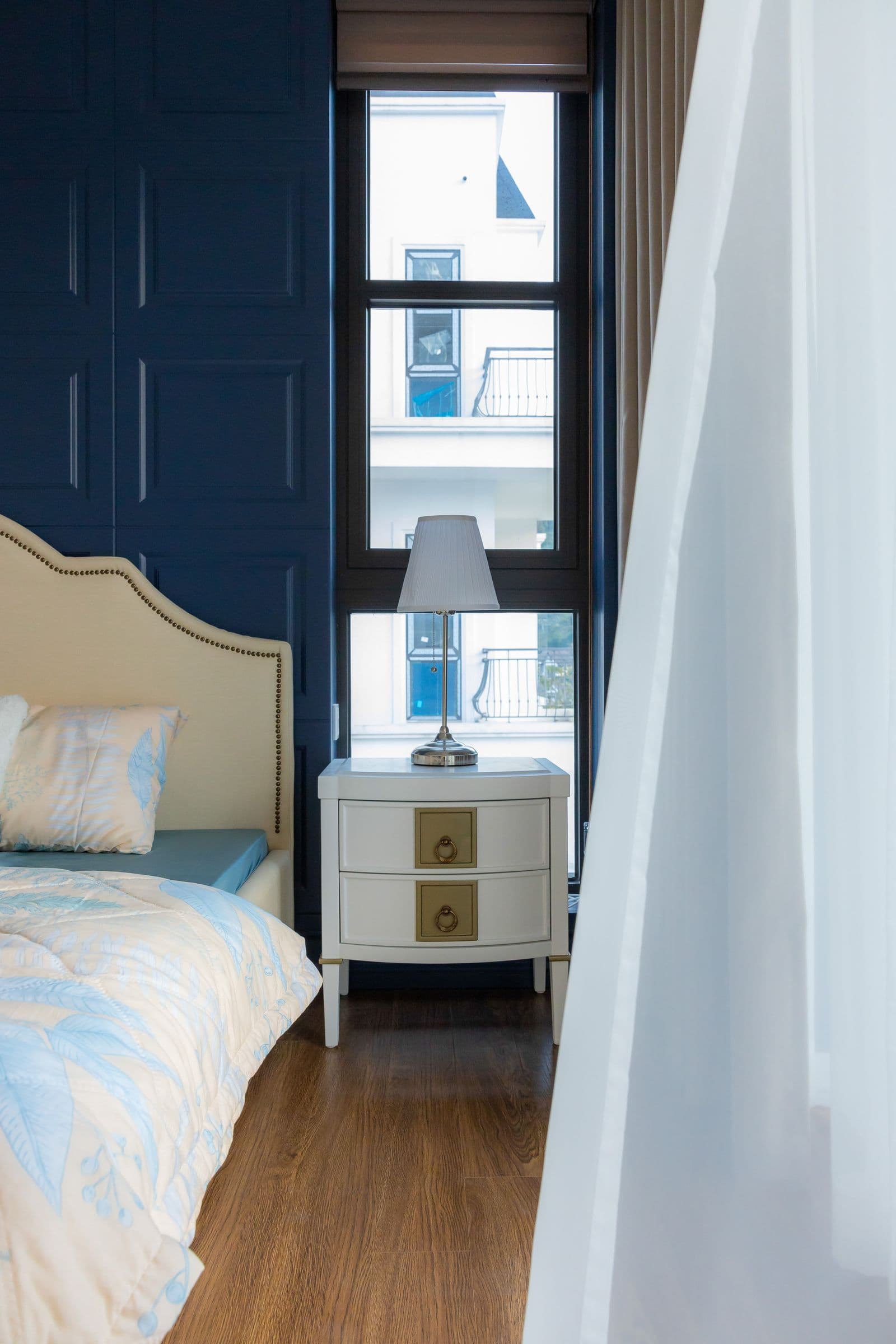 Stylish modern bedroom with neutral palette and large window