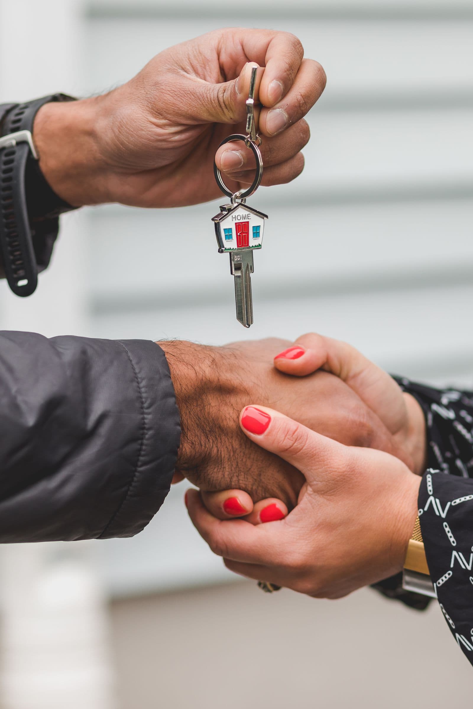 House keys handed over symbolising secured home warranty